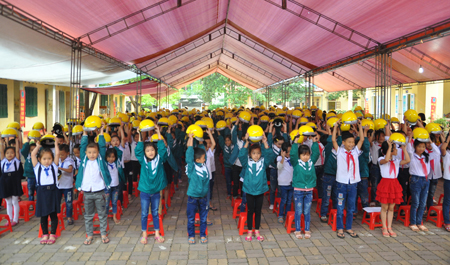 Học sinh Trường Tiểu học và THCS Âu Lâu, thành phố Yên Bái thực hiện đội mũ bảo hiểm đúng cách.