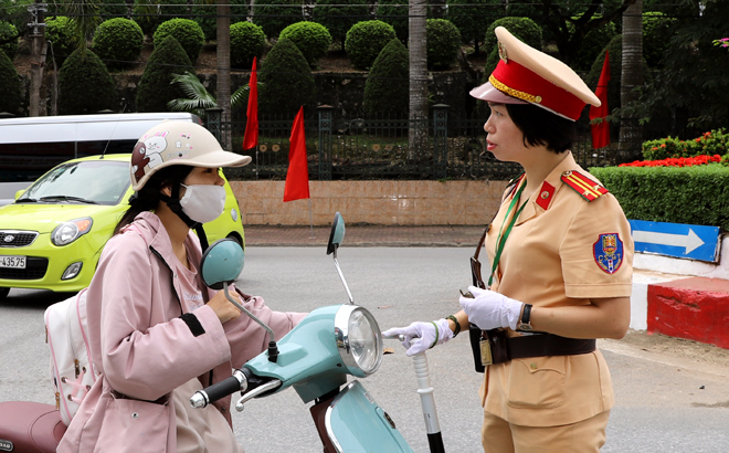Trung tá Trần Thúy Vinh tuyên truyền, nhắc nhở người tham gia giao thông chấp hành nghiêm quy định của Luật Giao thông đường bộ.